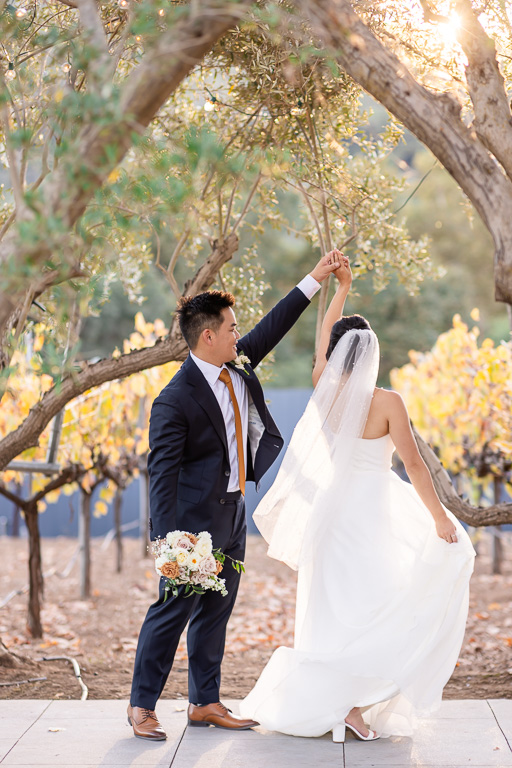groom giving the bride a little twirl