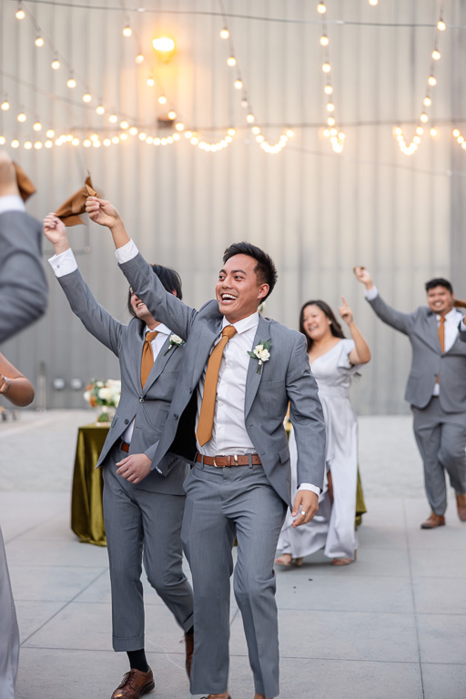groomsmen dancing as they enter reception