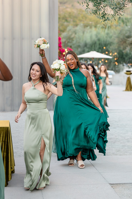 bridesmaids dancing their way into the reception