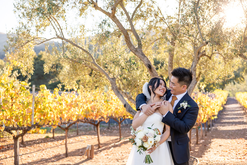 wedding portrait of the bride and groom with colorful autumn foliage