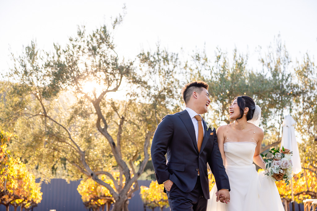 a happy natural looking wedding photo of the bride and groom during golden hour in the autumn