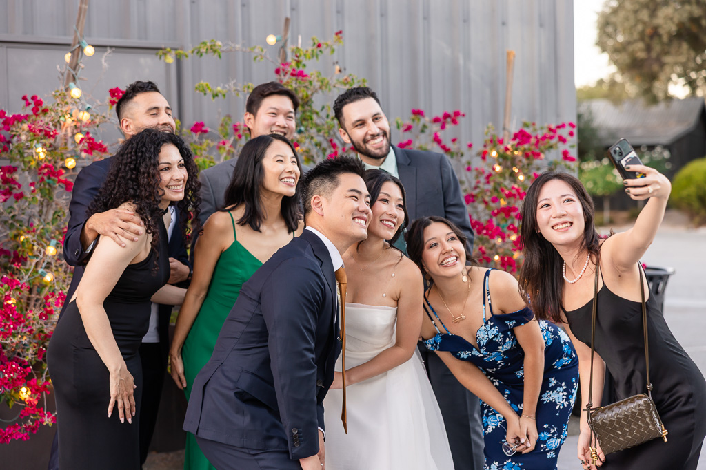 friends taking a selfie with the newlyweds