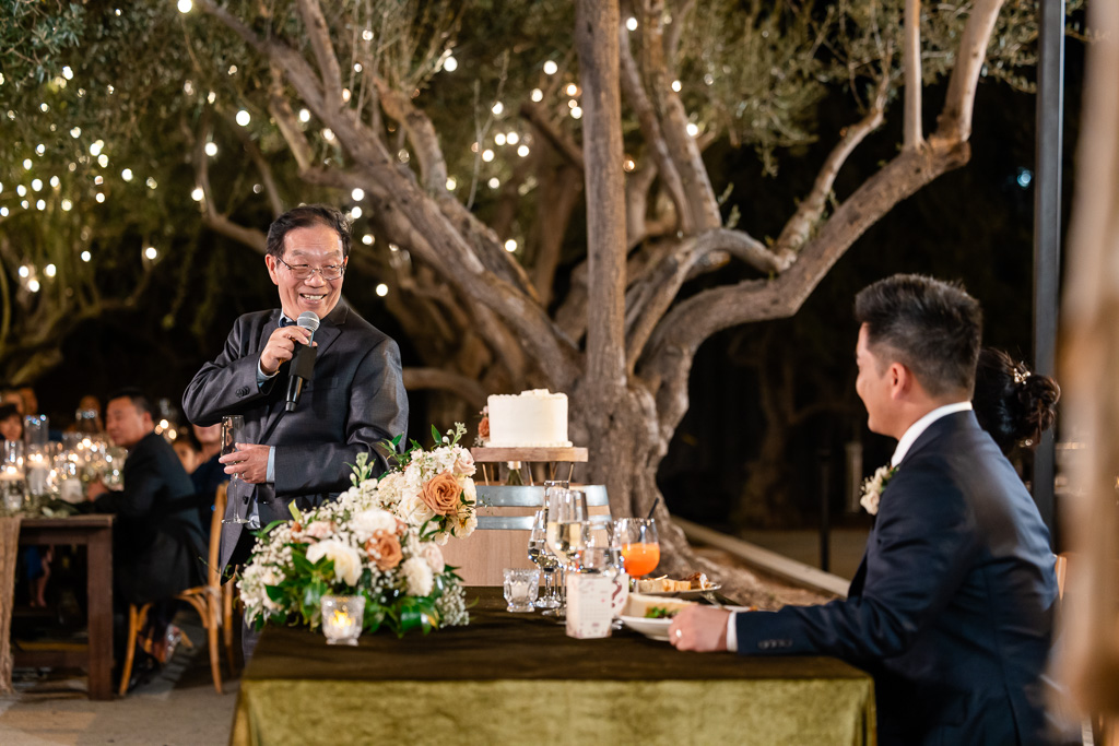 dad giving a dinner toast at MOHI Ranch outdoor at night