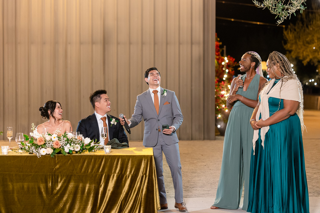 groomsman giving a dinner toast at MOHI Ranch at night