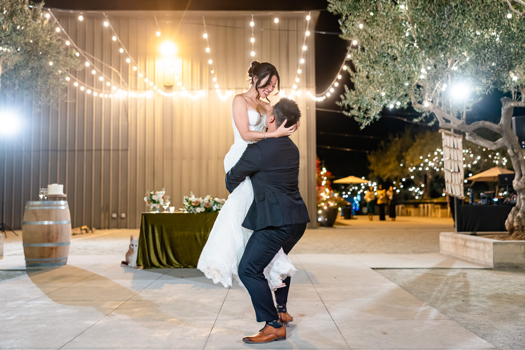 first dance lift with string lighting at night