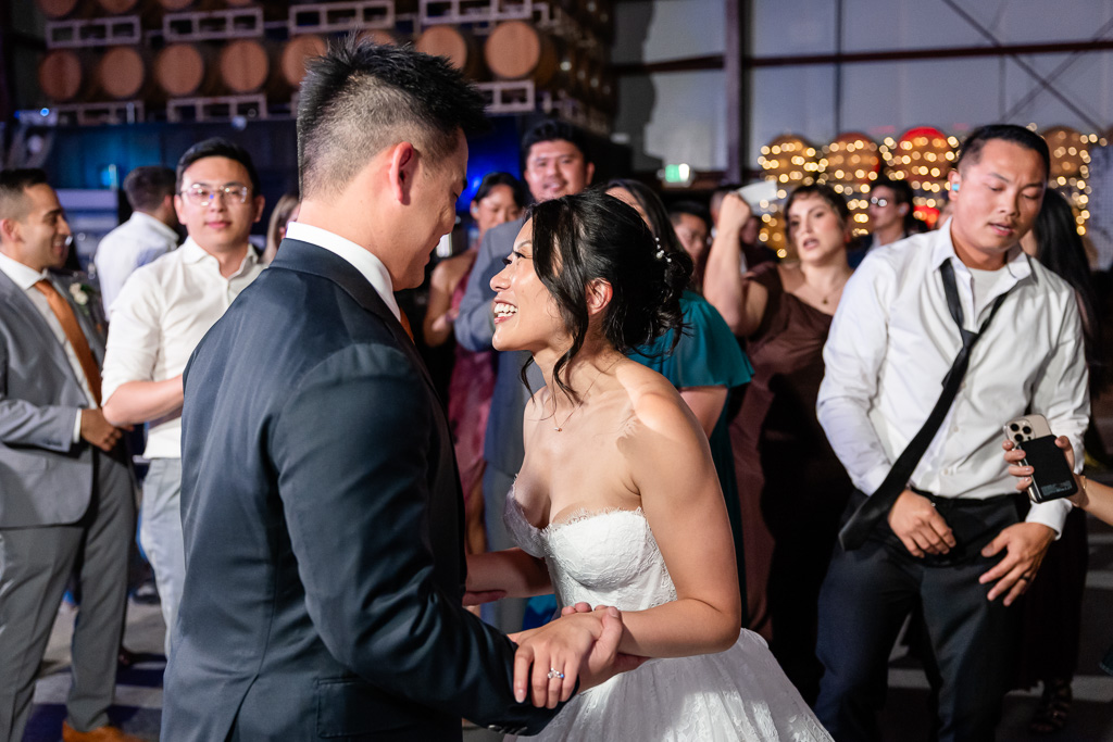 crowd gathered around the newlyweds on the dance floor