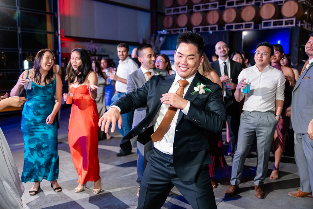 the groom enjoying himself on the dance floor