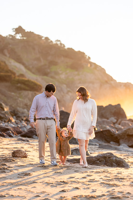 cute family photos with parents and baby at golden hour on the beach