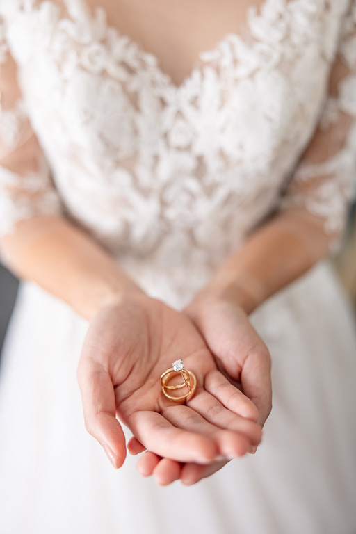 bride holding wedding rings in her palms
