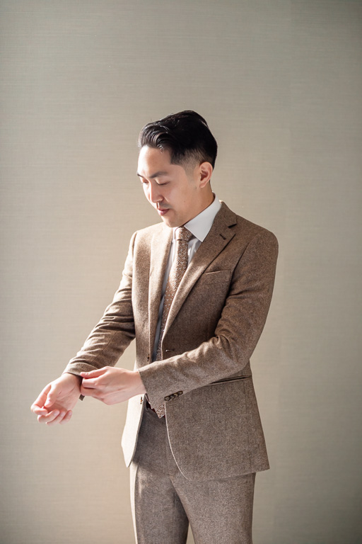 clean, side-lit solo portrait of the groom getting ready for wedding