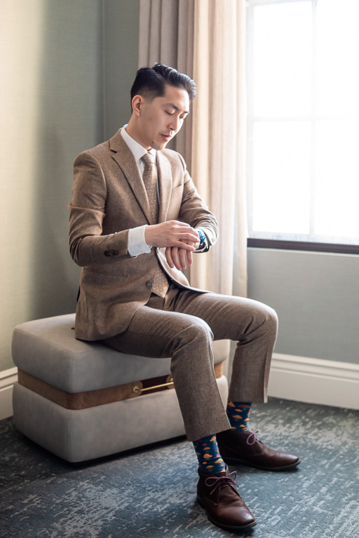 groom sitting and adjusting his sleeves and cuffs