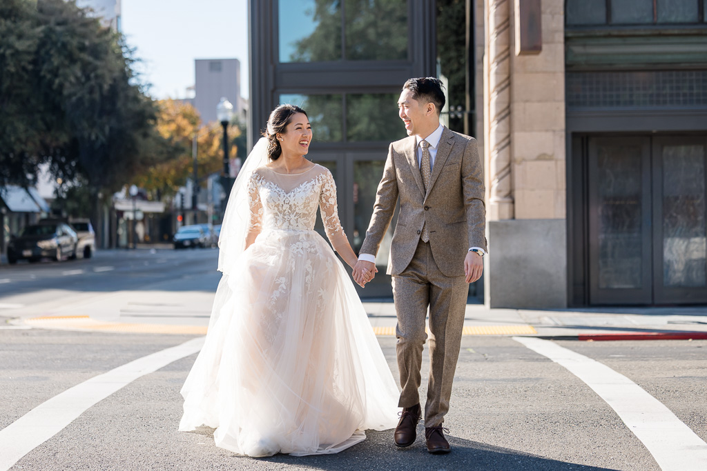 downtown Sacramento candid wedding photo on a crosswalk