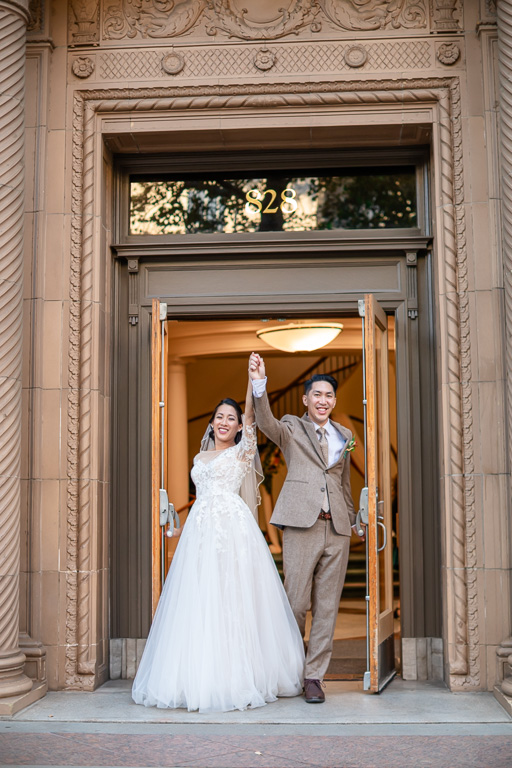 wedding photo coming out the Tsakopoulos door