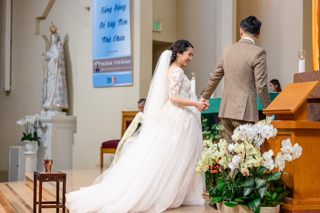 groom leading the bride up to the altar