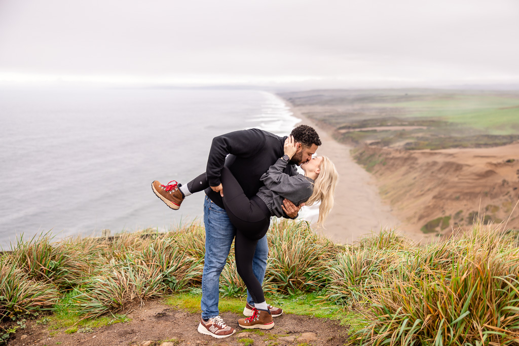 a dip and kiss high above a beach