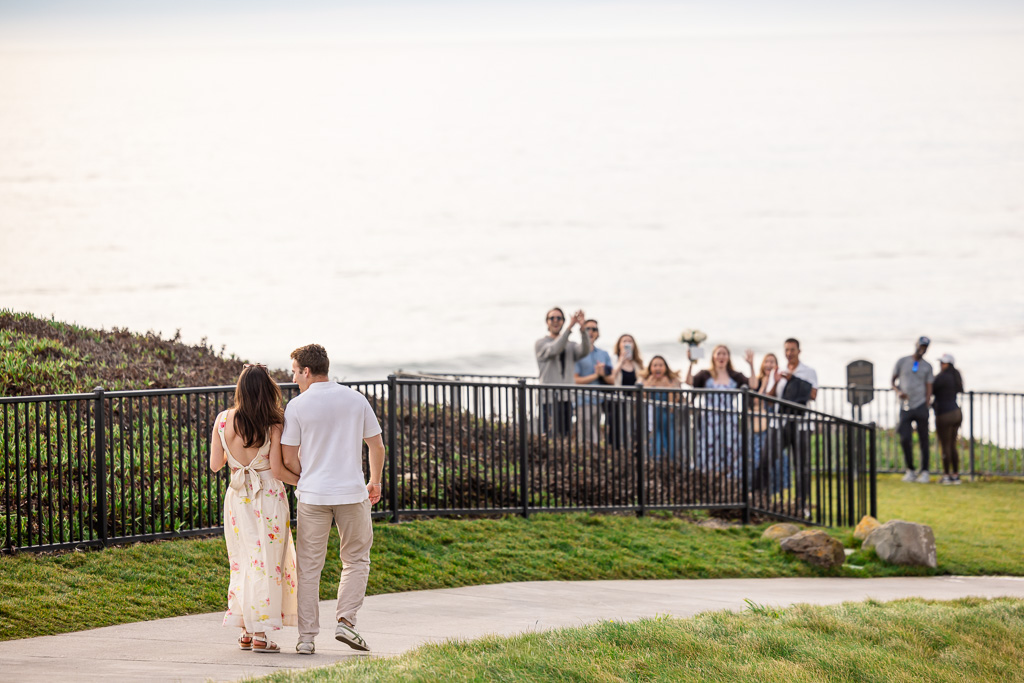friends hiding to surprise couple who just got engaged