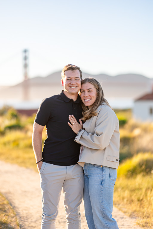 a couple in the Presidio in front of the Golden Gate Bridge