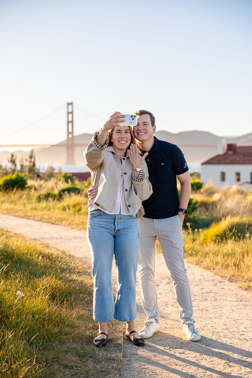 taking a celebratory selfie with the ring and the Golden Gate Bridge in the background