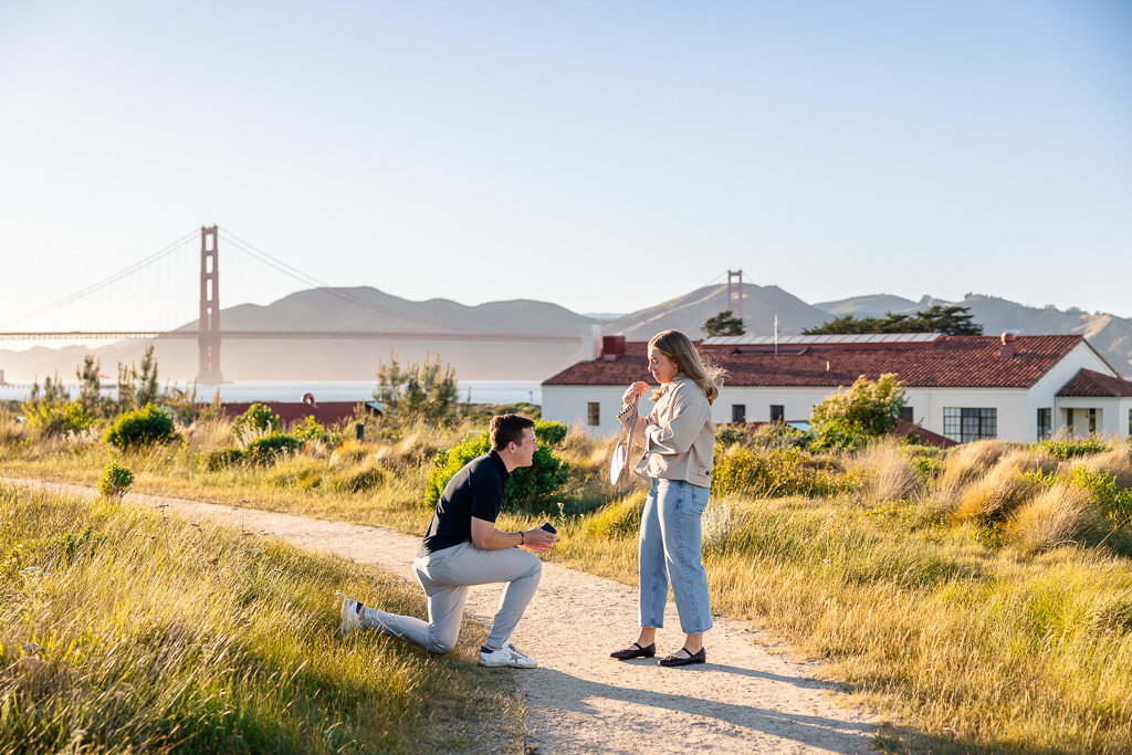 him getting down on one knee and her dropping her purse
