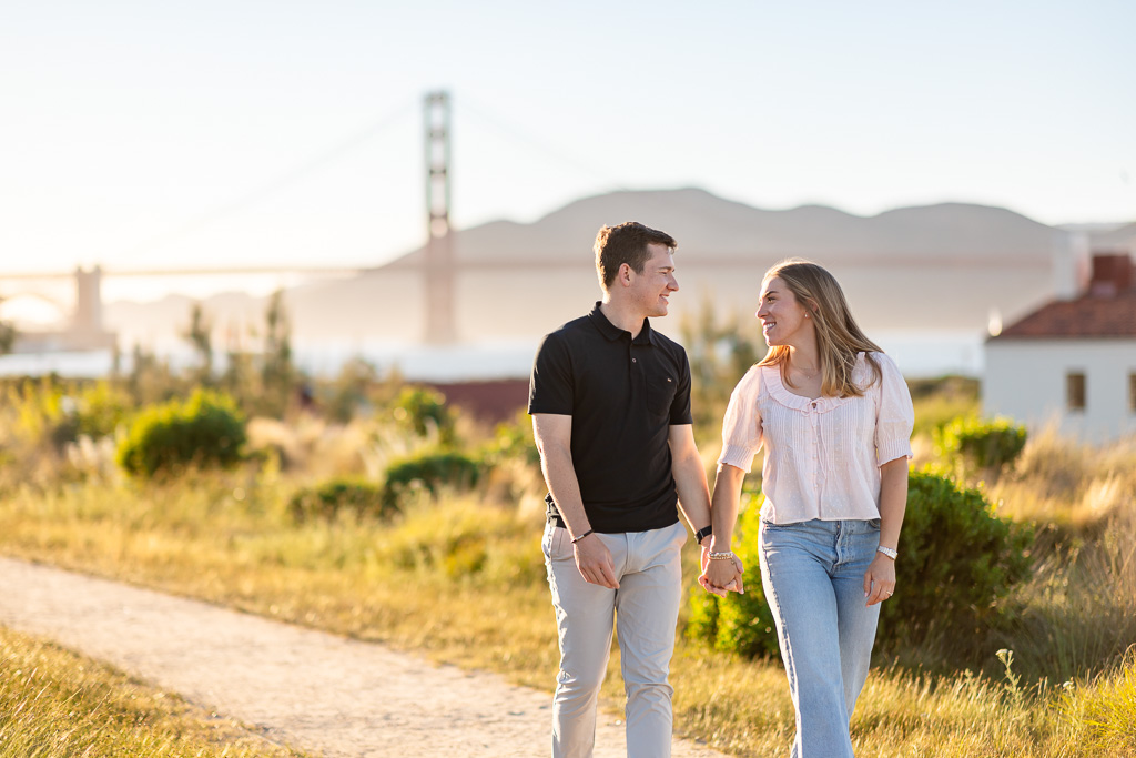 couple walking along a trail in San Francisco near the Golden Gate Bridge