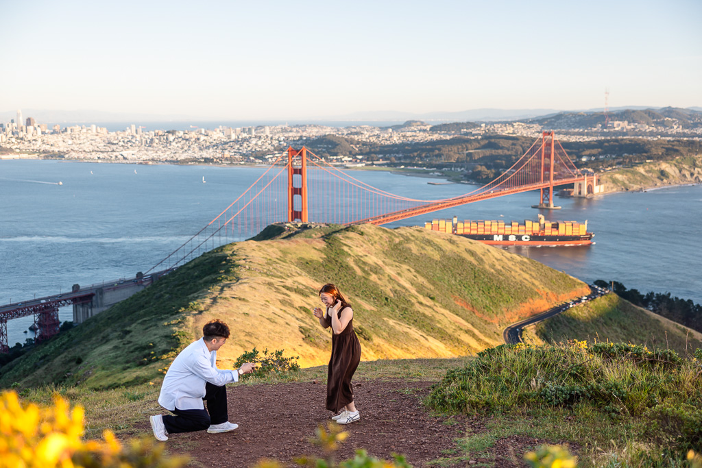 Golden Gate Bridge sunset hour surprise proposal with container ship passing under the bridge in the background