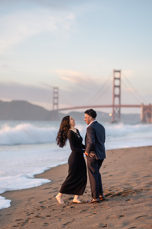 candid engagement photos at Baker Beach