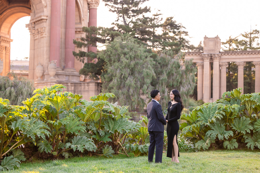 couple wearing all black standing in front of the Palace of Fine Arts