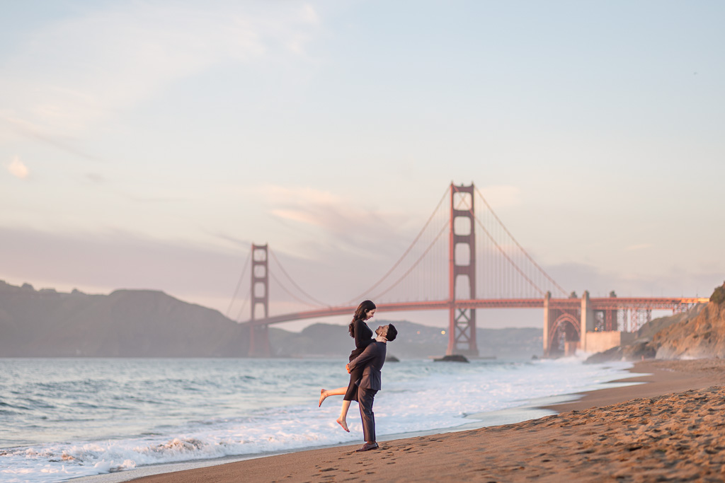 sunset engagement photos at Baker Beach with the Golden Gate Bridge in the background