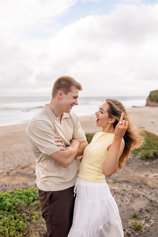 couple showing off the new engagement ring after proposing