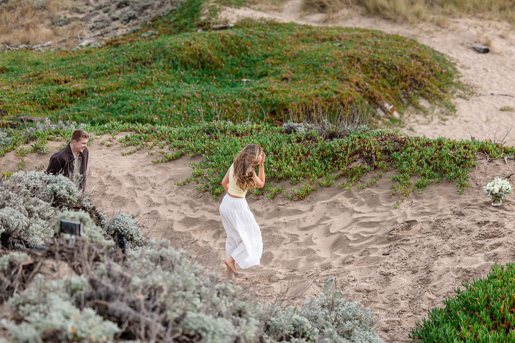 walking towards bouquets placed for marriage proposal