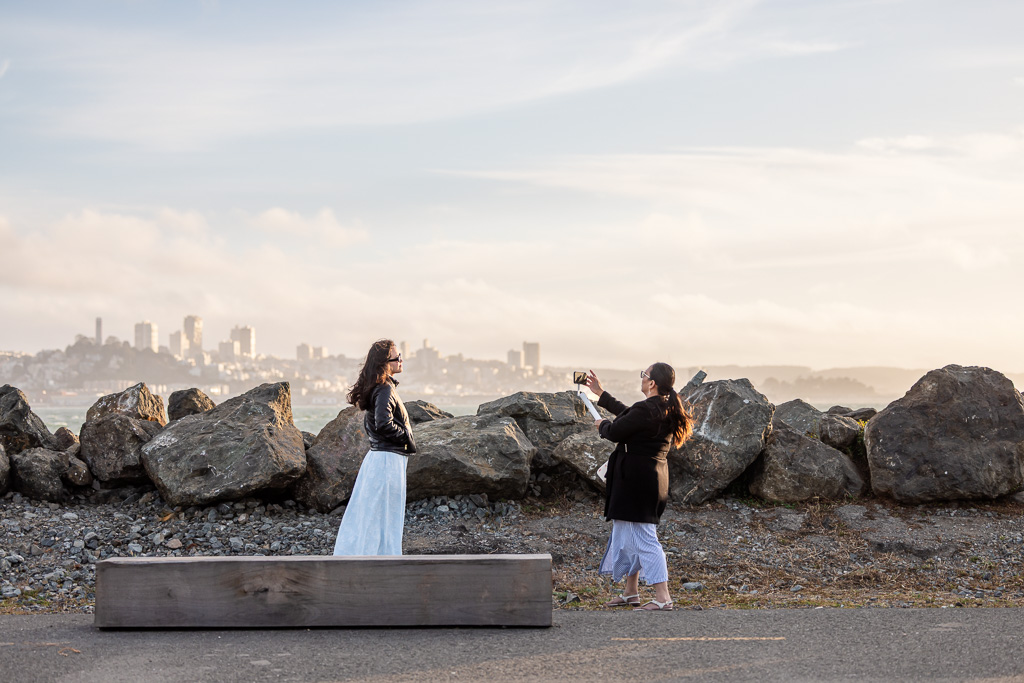 mom and daughter taking photos of each other at Treasure Island