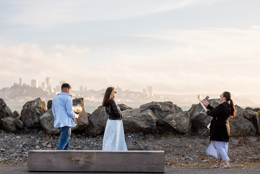 walking up with flowers from behind for a surprise proposal