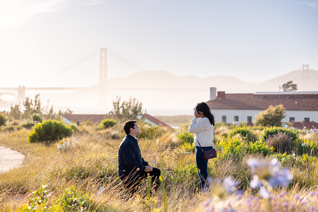 surprise proposal at Presidio vista point with a view of the Golden Gate Bridge