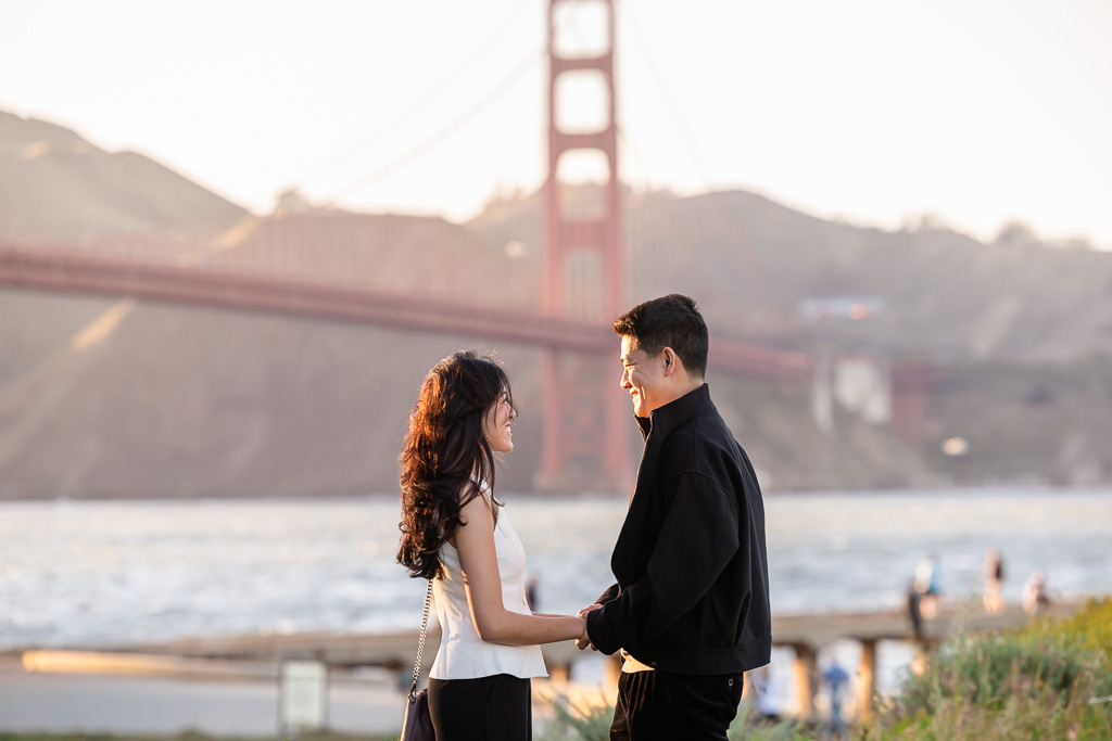 Asian couple at the Golden Gate Bridge during golden hour