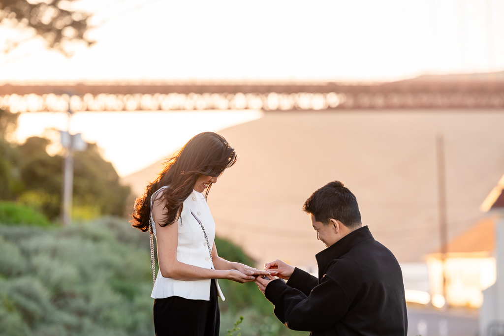 putting on the engagement ring while on one knee