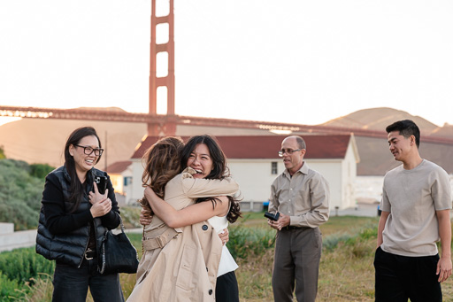 family surprising and congratulating the bride-to-be