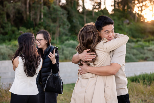family members congratulating couple on engagement