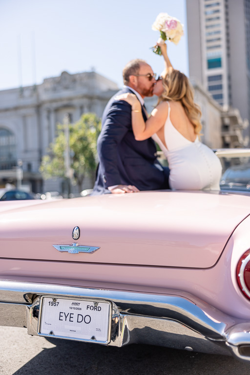 wedding photo of couple in a Thunderbird with an EYE DO license plate