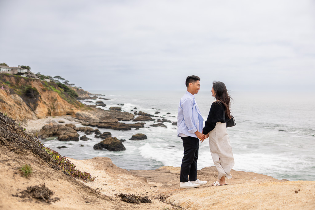 couple standing at a cliffside coastal overlook