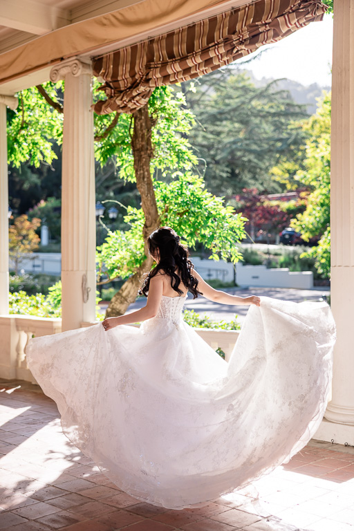 bride whimsically playing with her dress