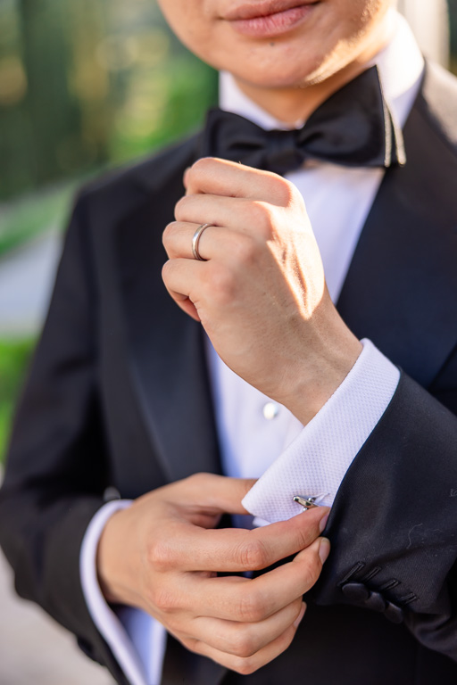 groom getting ready pose and adjusting cuff links