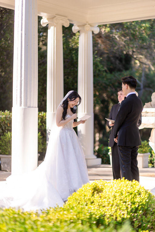 bride smiling and giving her wedding vows
