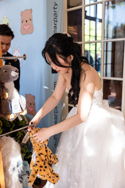 bride picking out a stuffed animal
