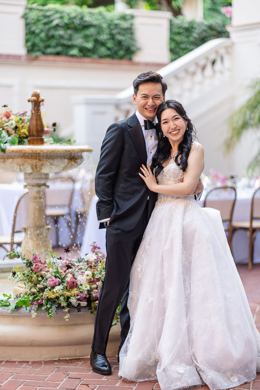portrait of the newlyweds near the fountain at the Spanish Courtyard
