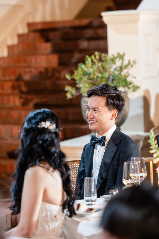 bride and groom listening to wedding toasts