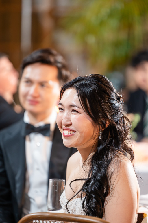 bride and groom reaction to wedding toast from their friend