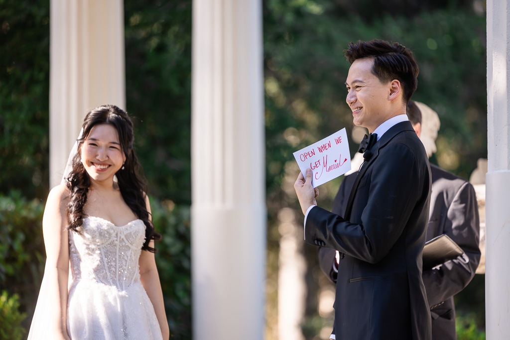 groom showing off a fun letter that the bride had written him