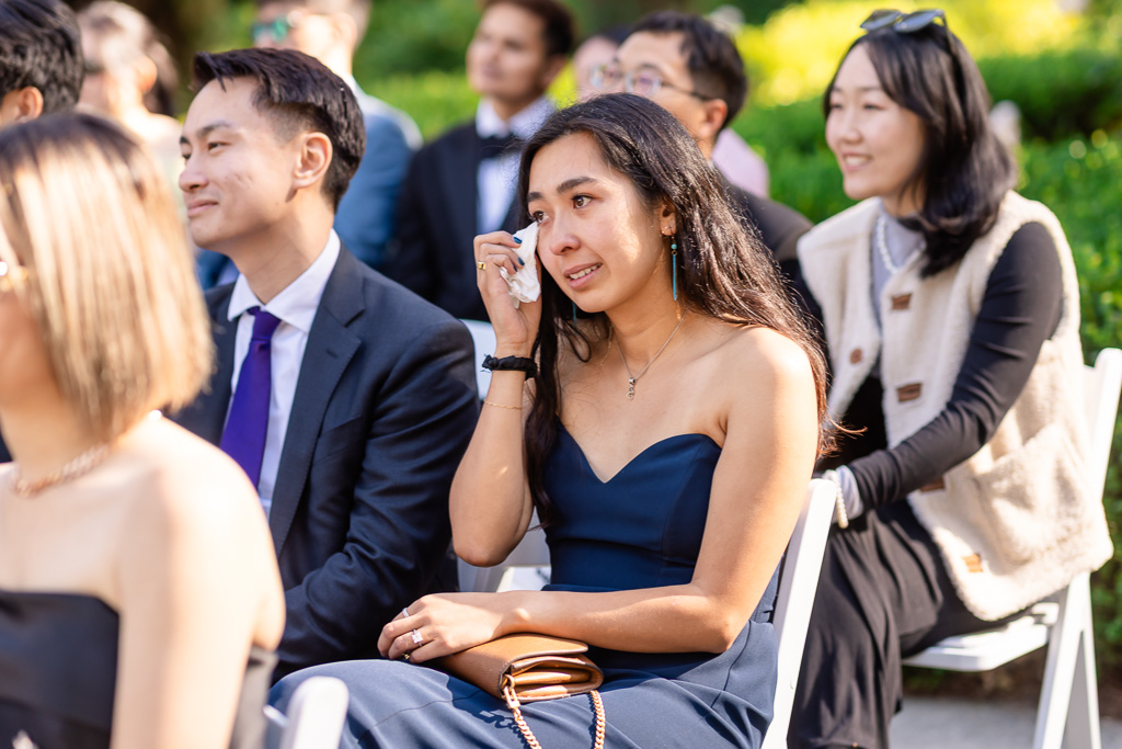 guests reacting to an emotional moment of the ceremony