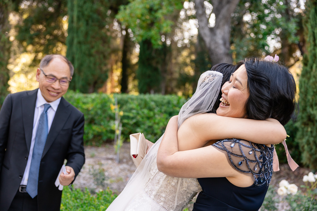 bride giving her mom a huge hug right after wedding ceremony