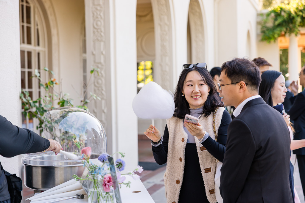 guests getting cotton candy at the wedding